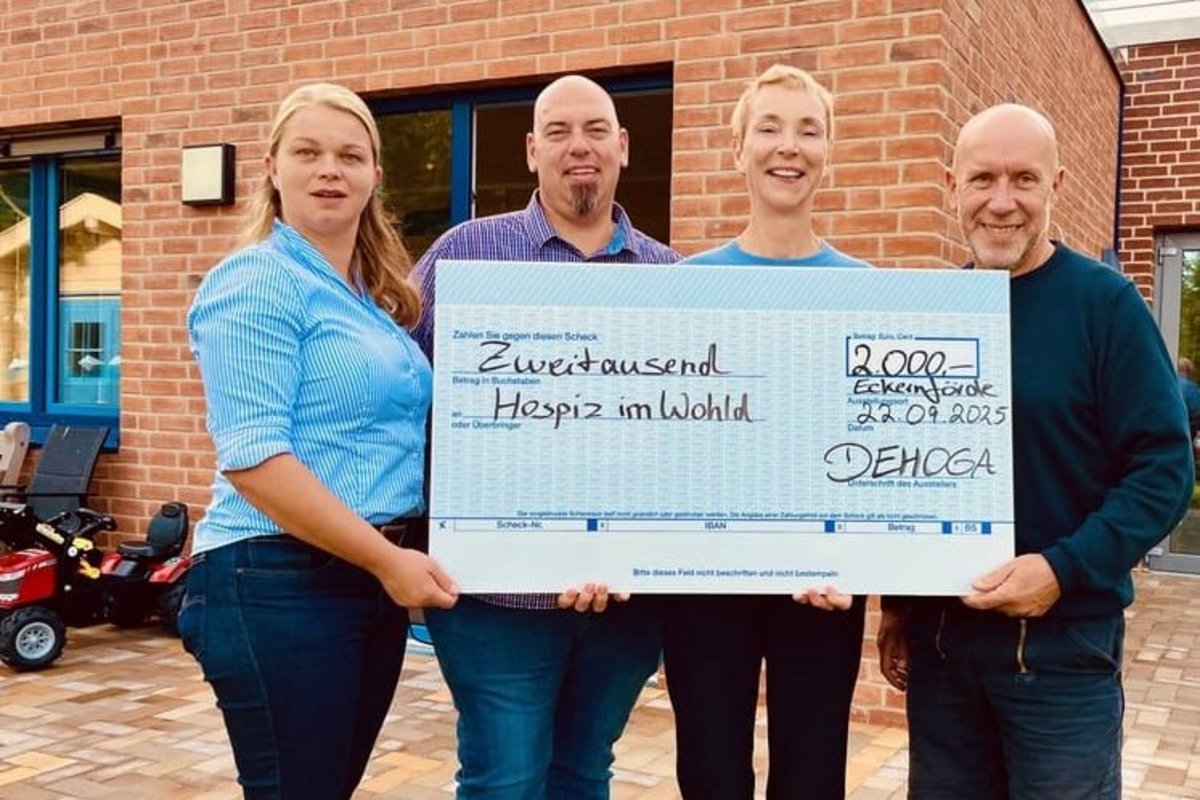 Spender und Geschäftsführerin halten einen Spendenscheck