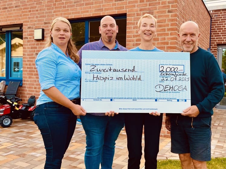 Spender und Geschäftsführerin halten einen Spendenscheck